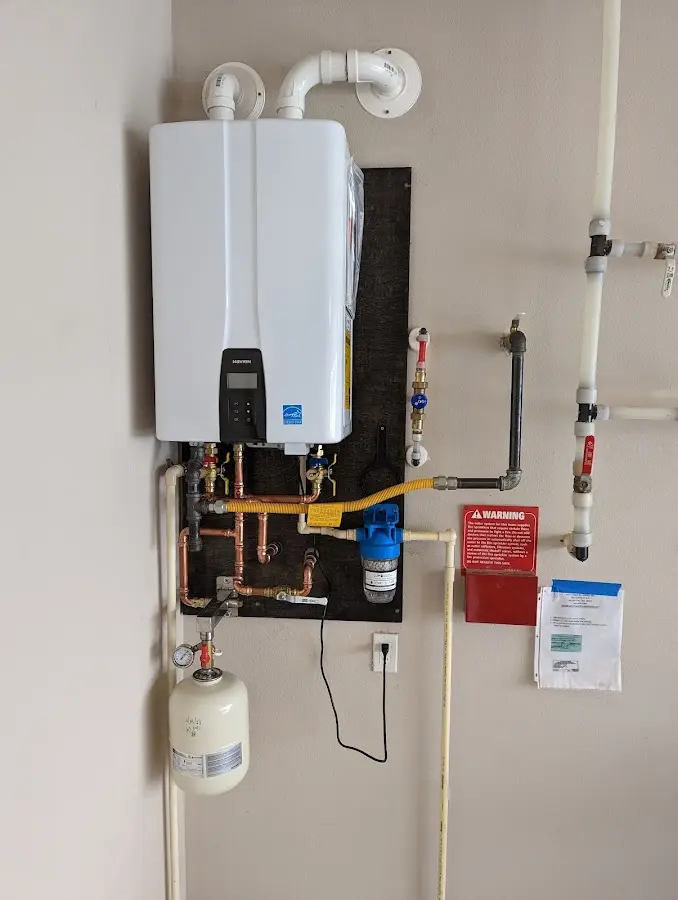 Professional plumber installing copper piping in a Ashby home
